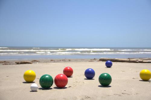 a group of different colored balls on the beach at 1st Row, Unobstructed Gulf Views, Pet-Friendly! in Freeport