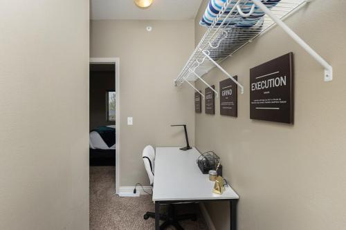 a office with a desk and a room with a bed at Stylish & Spacious, Pool, Nintendo Switch, King bed in West Des Moines