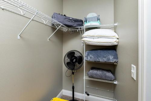a walk in closet with a fan and towels at Stylish & Spacious, Pool, Nintendo Switch, King bed in West Des Moines