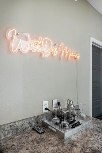 a neon sign that says wet die mirrors on a wall at Stylish & Spacious, Pool, Nintendo Switch, King bed in West Des Moines