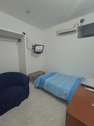 a bedroom with a bed and a tv on the wall at Mini apartamento 2 habitaciones in Ciudad Guayana