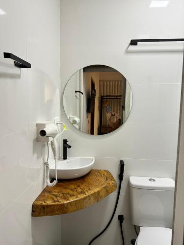 a bathroom with a sink and a mirror at Kim Casa BH in Belo Horizonte