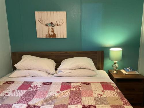 a bedroom with a bed with a quilt on it at Algonquin Waterfront and Winter Paradise With Sunsets in Algonquin Highlands