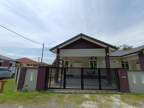 a house with a gate in front of it at Serai Homestay in Dungun