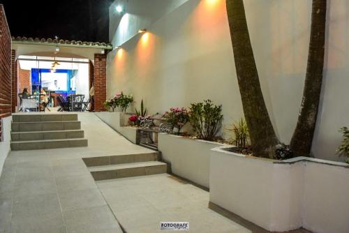 a patio with stairs and a tree in a building at Elegant House with Party Room in Santana do Livramento