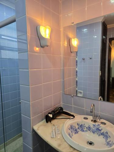 a bathroom with a sink and a mirror at Elegant House with Party Room in Santana do Livramento