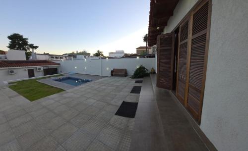 a house with a patio and a swimming pool at Elegant House with Party Room in Santana do Livramento