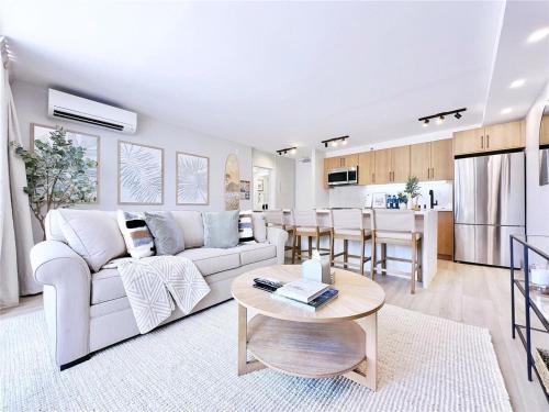 a living room with a white couch and a table at Huge patio I Luxury 1BR Banyan I Washer I Free park I 5' Beach in Honolulu