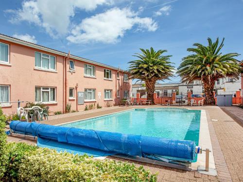 a large pool with an inflatable slide at Garden Apartment - Uk44654 in Paignton