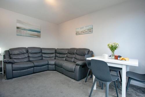 a living room with a couch and a table at Garden Apartment - Uk44654 in Paignton