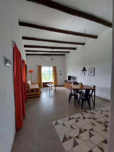 a living room with a table and a couch at Dos teros cabañas in Raco