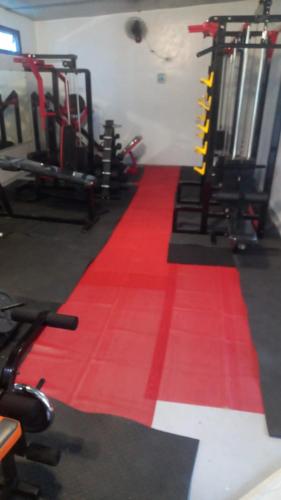 a red carpet in a gym with a red floor at Shawe pension house in San Remigio