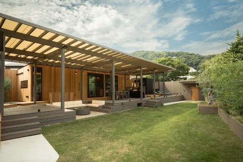 a house with a large backyard with grass at Tiny Base The Irita-hama in Shimoda