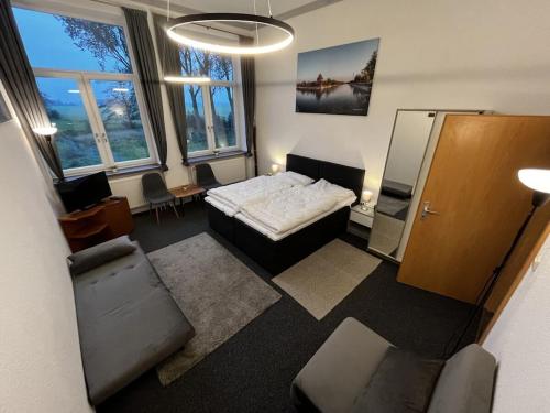 a room with a bed and a couch in it at EcoLodge Loft Comfortable holiday residence in Oesterdeichstrich