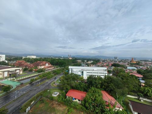 an overhead view of a city with a road and buildings at Vetro11 Beside QEH1 by JUNE Homestay in Kota Kinabalu