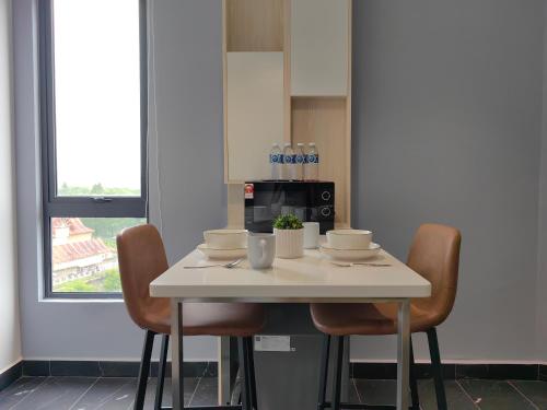 a white table with chairs and drinks on it at Vetro11 Beside QEH1 by JUNE Homestay in Kota Kinabalu