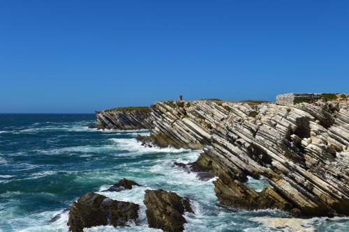 a group of rocks in the ocean near the water at Mercearia D'Alegria Boutique B&B in Peniche
