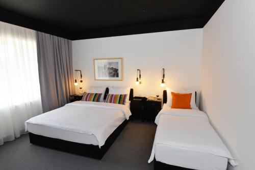 A bed or beds in a room at The Loop Hotel