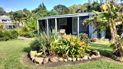 a house with a garden in front of it at Cosy cottage close to town in Whangarei