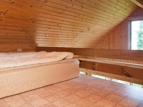 a wooden room with a bed and a window at 6 person holiday home in Store Fuglede-By Traum in Store Fuglede