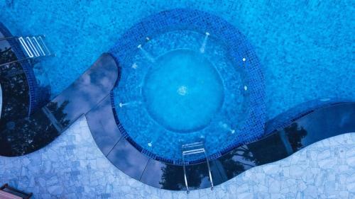 an overhead view of a blue toilet in a pool at Infenta's Villa in Pandattarippu