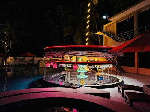a merry go round at a resort at night at Infenta's Villa in Pandattarippu