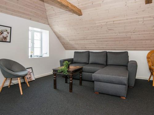 a living room with a couch and a table at 6 person holiday home in Bredebro in Bredebro