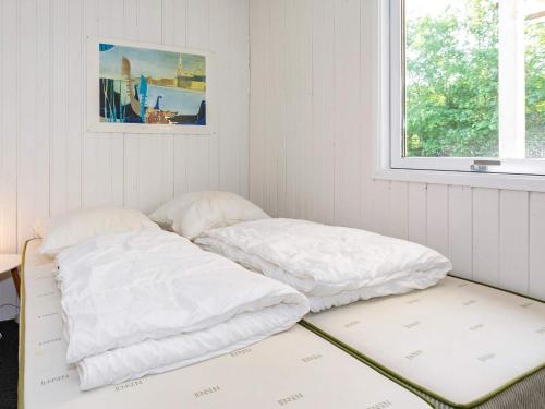 two white pillows sitting on a bed in a room at 6 person holiday home in Hals-By Traum in Hals