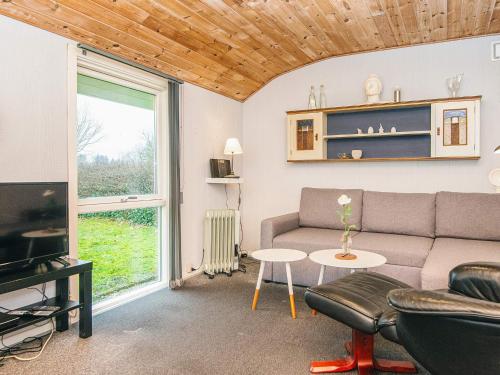 a living room with a couch and a table at 4 person holiday home in Grindsted-By Traum in Grindsted