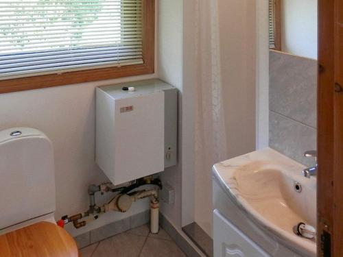 a bathroom with a toilet and a sink at 4 person holiday home in Grindsted-By Traum in Grindsted