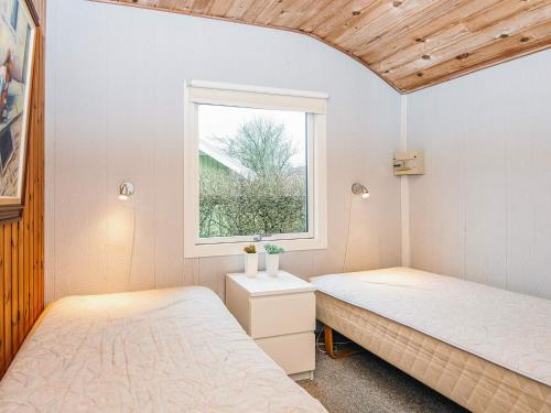 two beds in a room with a window at 4 person holiday home in Grindsted-By Traum in Grindsted