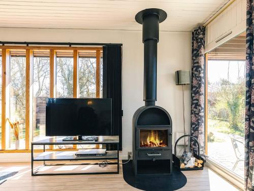 a fireplace in a living room with a tv at 6 person holiday home in Læsø in Læsø