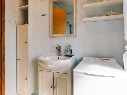 a bathroom with a sink and a washing machine at 6 person holiday home in Læsø in Læsø