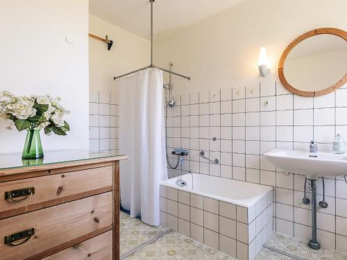 a bathroom with a sink and a toilet and a tub at 8 person holiday home in Harpelunde in Harpelunde