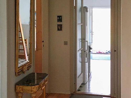 a hallway with a mirror and a stair case at 8 person holiday home in Harpelunde in Harpelunde