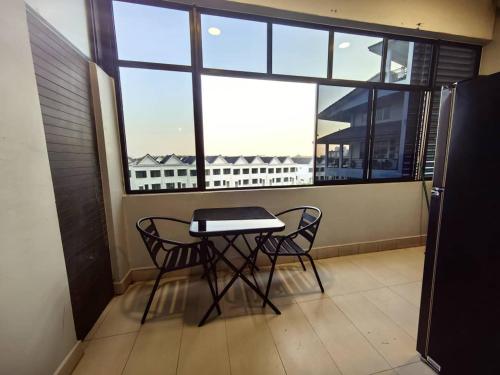 a balcony with a table and two chairs and a window at Anjung Seri-Amansari Residence Seri Alam 1BR, 1-2 Pax in Masai