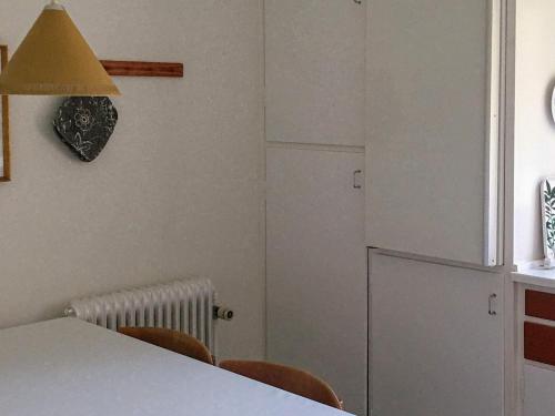 a kitchen with a table and chairs and a refrigerator at 8 person holiday home in Harpelunde in Harpelunde