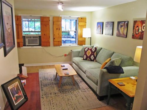 a living room with a couch and a table at Cozy Vintage Chicago Apartment near Downtown in Chicago