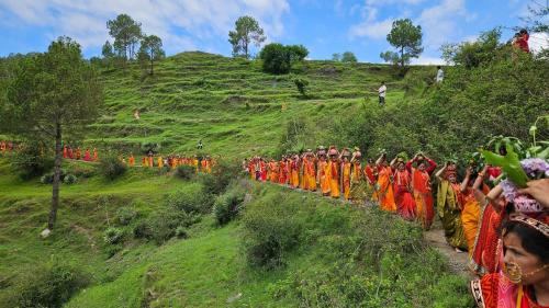 a group of people walking down a hill at Eja Homestay Falsima in Almora