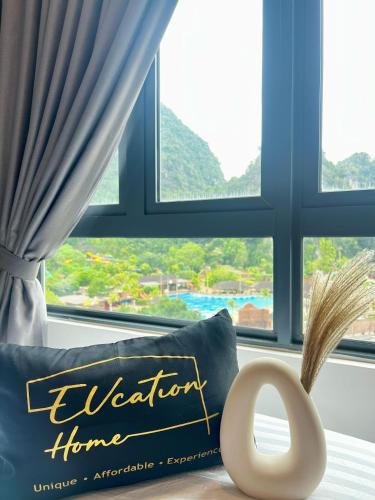 a pillow with the word vacation home in front of a window at Sunway Onsen Ipoh by EUcation Home in Tambun