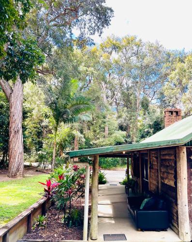 a pavilion with a green roof in a park at Ferns Hideaway Resort in Byfield