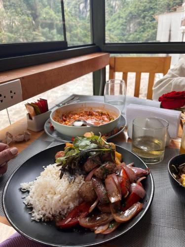 a plate of food on a table with rice at Velvet Sunrise Hotel in Machu Picchu