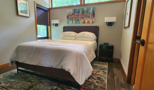 a bedroom with a large bed and a window at Piedmont Grove Lodging in Roseland