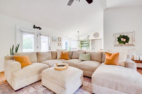 a living room with a couch and two ottomans at Red Juniper Retreat 
