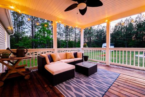 a screened in porch with a couch and a table at Red Juniper Retreat 