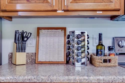 a kitchen counter with a knife block and a bottle of wine at Red Juniper Retreat 