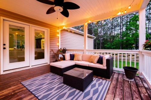 a screened in porch with a couch and a coffee table at Red Juniper Retreat 
