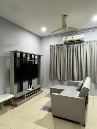 a living room with a couch and a flat screen tv at Ss Homestay By Stella Ketiau,Putatan in Kota Kinabalu