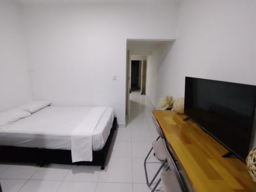 a bedroom with a bed and a flat screen tv at Plaza De Bolívar in Pereira