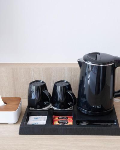 a black coffee maker on a tray on a counter at Sascanaluna Padma Bali in Kesiman